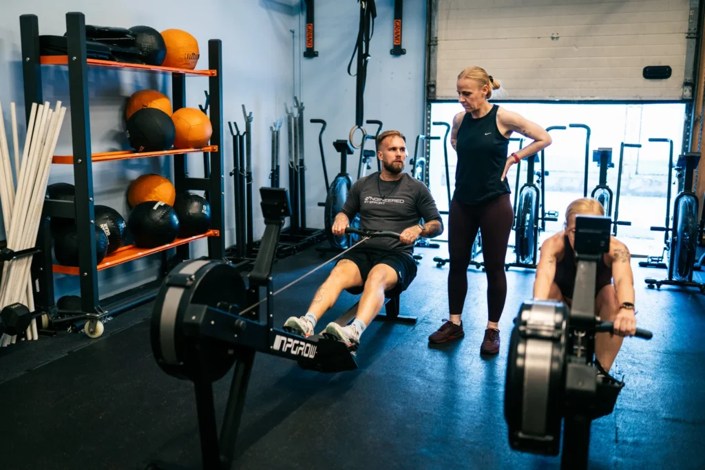 Trenerka nadzoruje trening na ergometrach